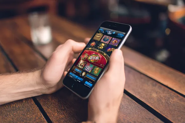 SPINARA App — Fast, responsive, and optimized for all devices A cheerful woman in traditional clothing using her smartphone during a festive moment, showing how easily the SPINARA app fits into everyday life.